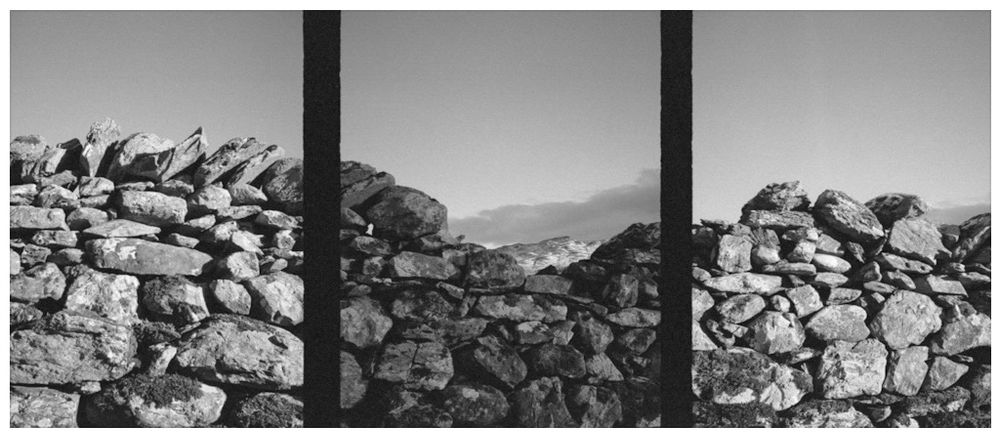 A black and white half frame triptych photograph of an undulating dry stone wall. Each image captures the interlocking stones blending seamlessly together, with the top line mimicking the natural flow of the land - a blend of natural beauty, clever engineering, and ecological design. 