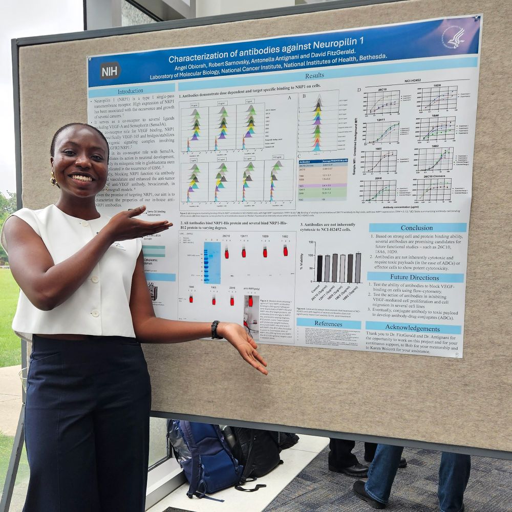 Angel Obiorah is standing in front of a poster presenting her research in David Fitzgerald’s lab through the National Institutes of Health Postbac Program. Image courtesy of Angel Obiorah.