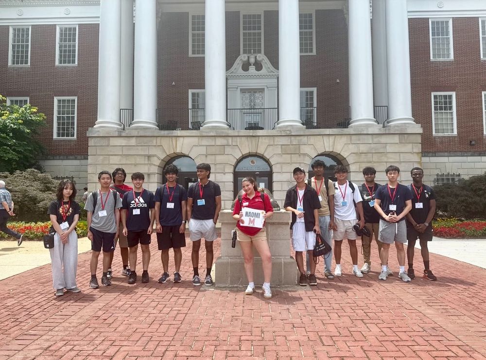 Orientation advisor standing with a group of incoming freshmen in front of McKeldin Library