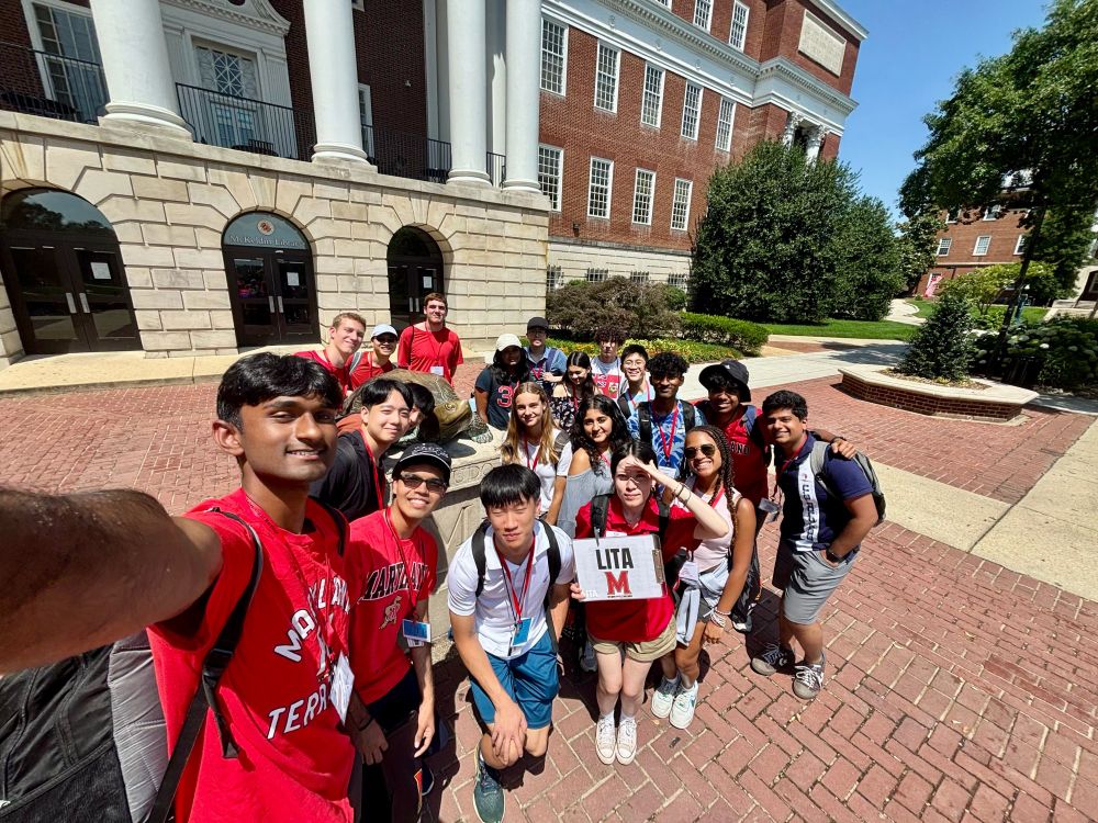 Group of incoming freshmen taking a selfie in front of McKeldin Library
