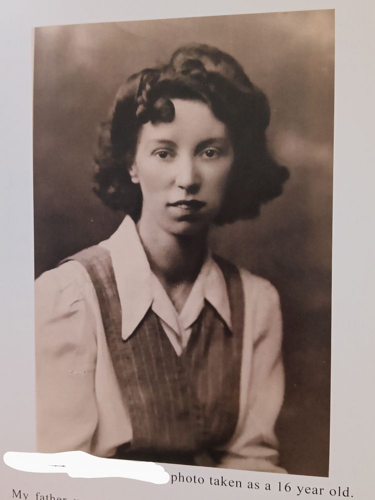 A black and white photo of my teenage grandma, wearing what I think is a school uniform. It's a white collared shirt with a small vest over it