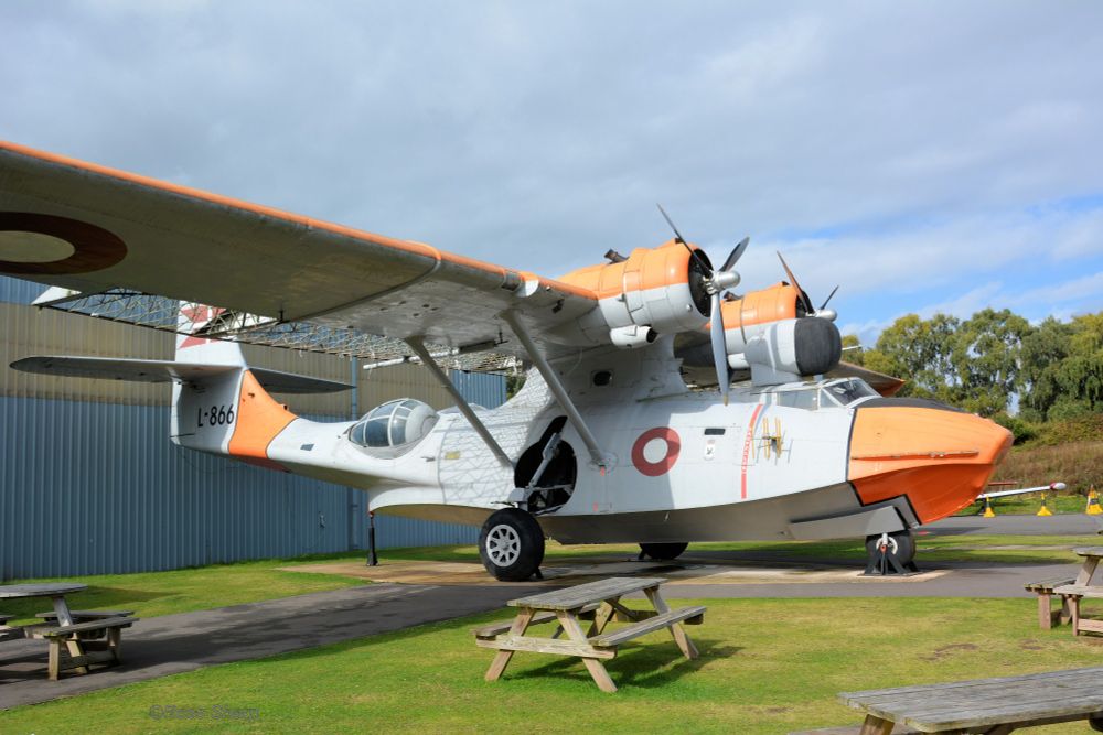 Designed, pre WW2, as a patrol flying boat, the Catalina (a name given to it by the Royal Air Force, then adopted by the US authorities) was built both as a flying boat and an amphibian, in the USA and Canada. This classic design, seen here parked outside one of the hangars at the RAF Museum, Midlands, is in the colours of the Royal Danish Air Force. It was used extensively in the Arctic, and in Greenland it carried everything from food supplies to dog sled teams! The -6A is distinguished by its large radar radome situated directly above the pilots.