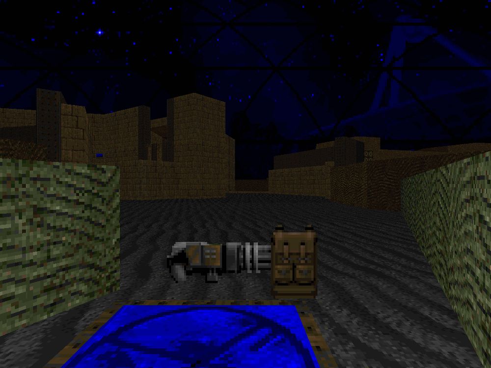 doom screenshot of a strangely shaped outdoor area under a blue sky, with a large satellite dish in the distance