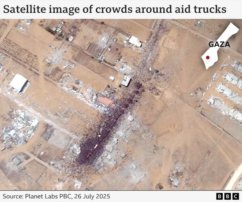 The image, released by Planet Labs, shows dense crowds gathered around 15 aid trucks in Gaza. The exact number of trucks can't be confirmed because they are barely visible through the mass of bodies.