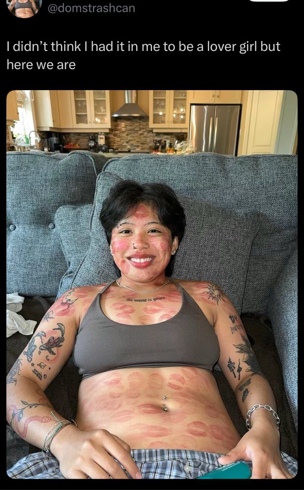 Original post of redraw. Woman reclining with a big smile covered in lipstick kisses