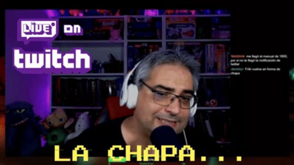 a man wearing headphones and glasses is talking into a microphone with the words live on twitch behind him