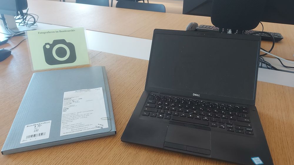 My old notebook, one of the files I worked on today, and a sign showing that I'm allowed to take pics of documents.