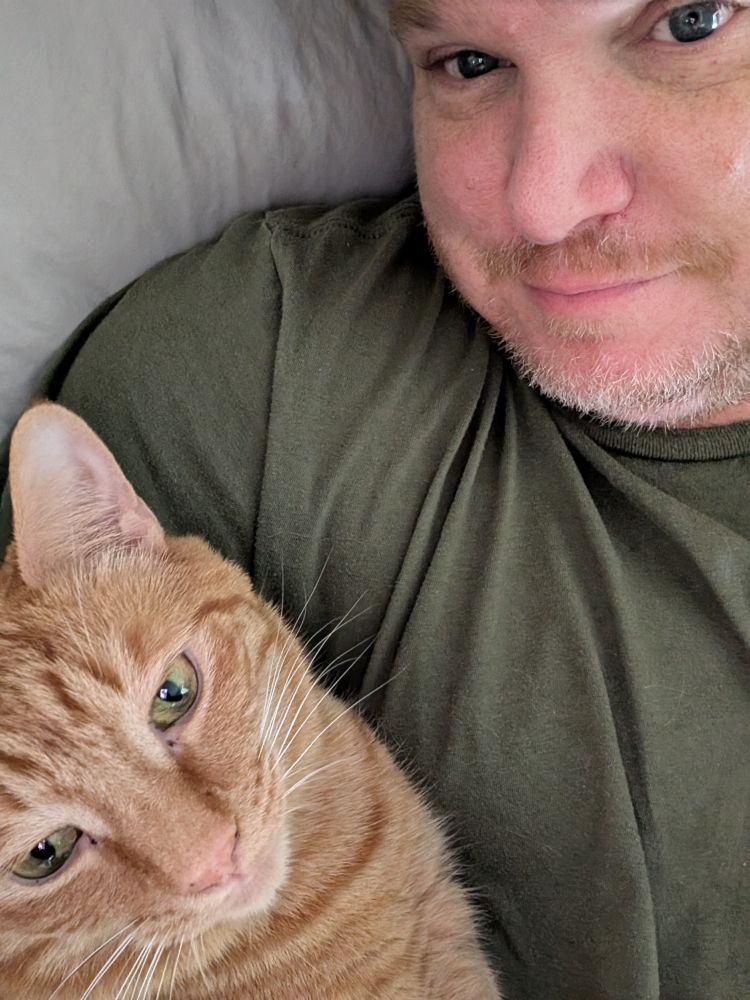 A man and his orange cat