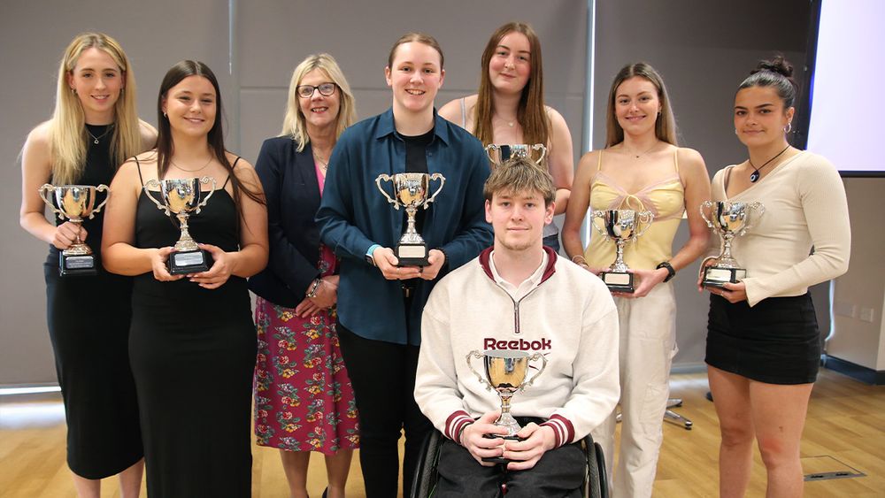 Sports students holding their trophies