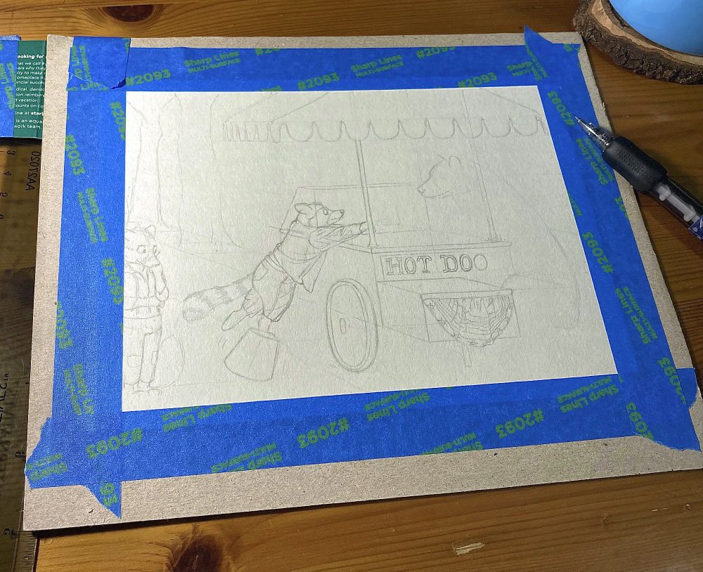 The beginnings of a pencil drawing. 
The drawing is incomplete, but the outline of a raccoon can be seen reaching for something from a food stand while balancing on an unstable bucket. 

The paper is taped to stiff cardboard with blue painter's tape surrounding it. It sits on a wooden table.