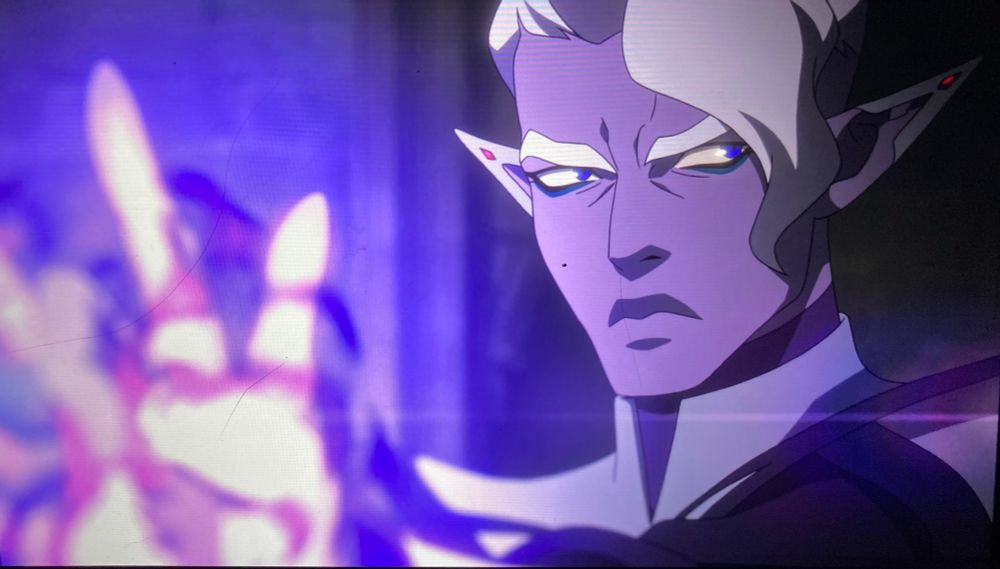 A still from the Mighty Nein. Still holding the spell, Essek looks to the side, evaluating his chances. He is not happy. 