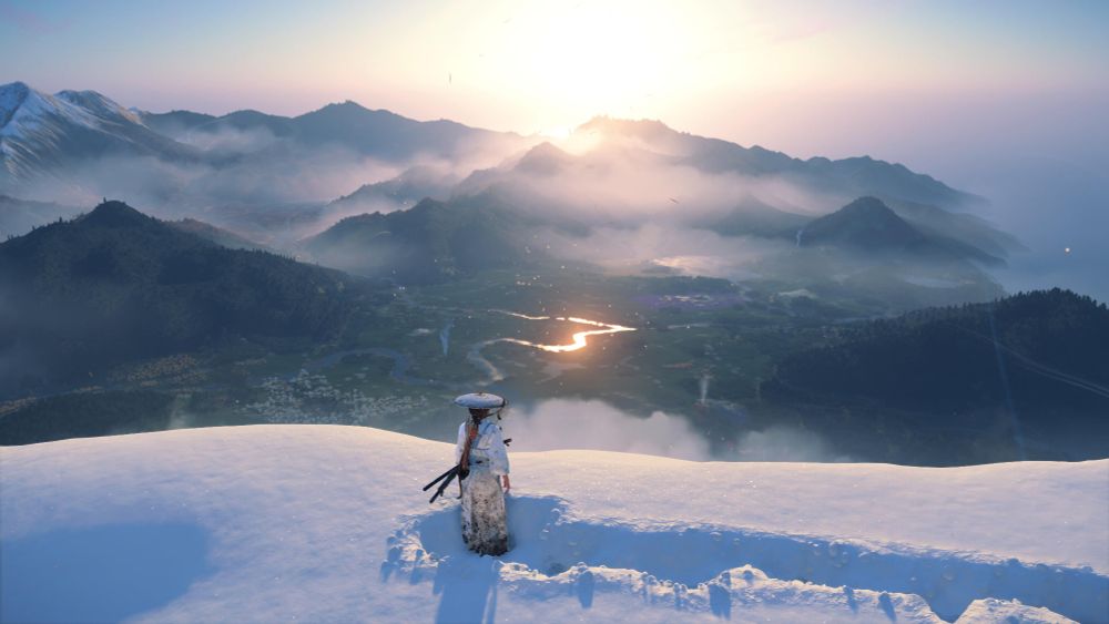 From Ghost of Yotei. My character, in traditional Japanese clothing, is standing on snow-topped mountain looking at the beautiful vista below, including a river, fields of flowers, hills and moutains. The sun is bright in the distance and clouds are settling over some of the mountains