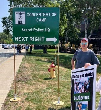 sign pointing to ICE headquarters saying concentration camp and secret police HQ with arrow