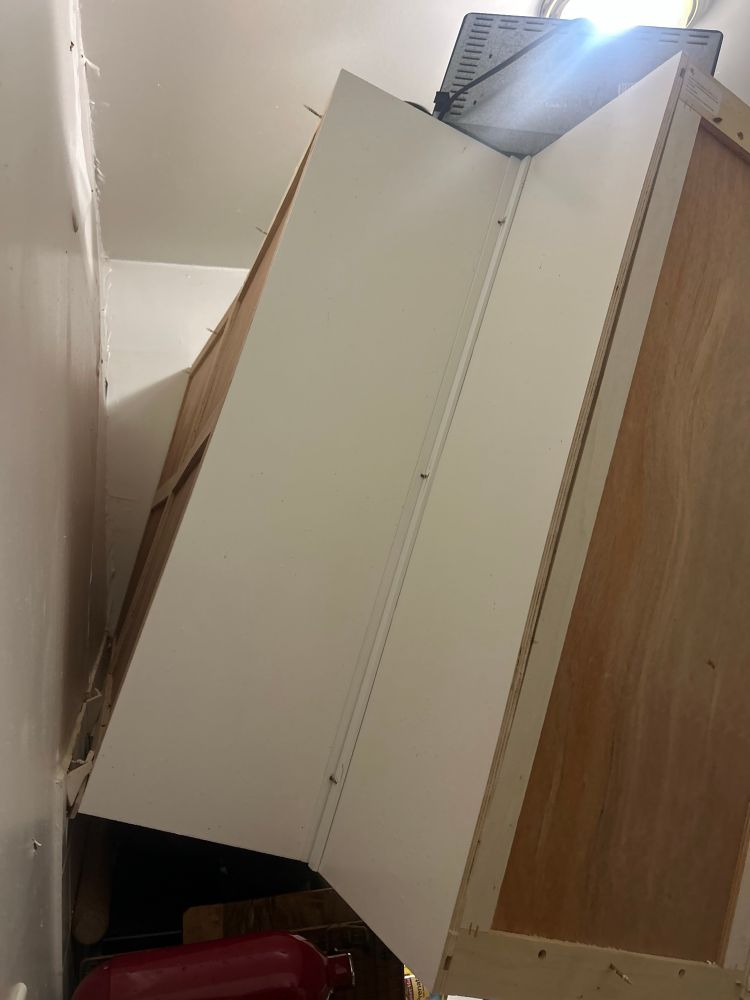 Kitchen cabinet hanging off wall 