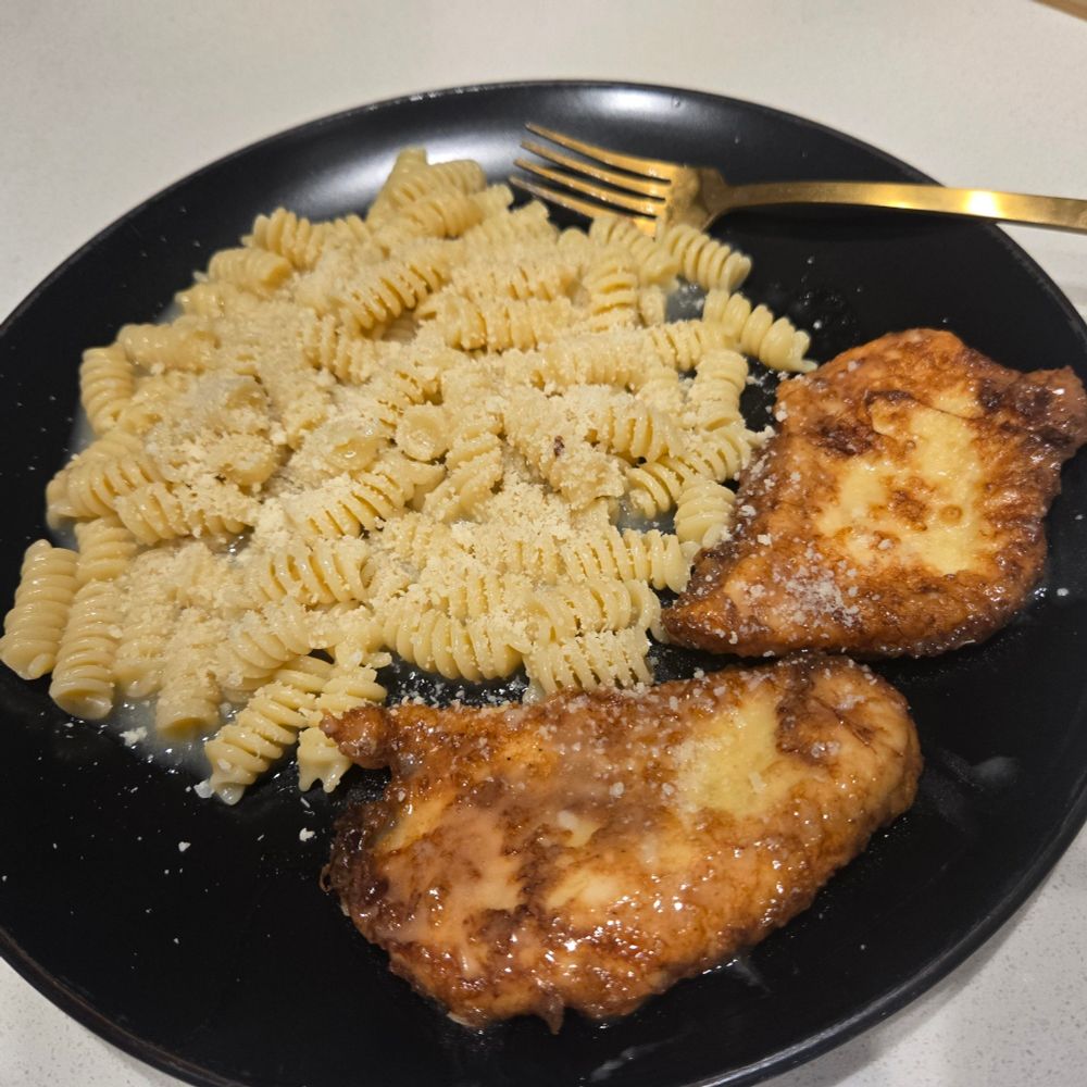 A plate of Chicken Francese and pasta ready to serve