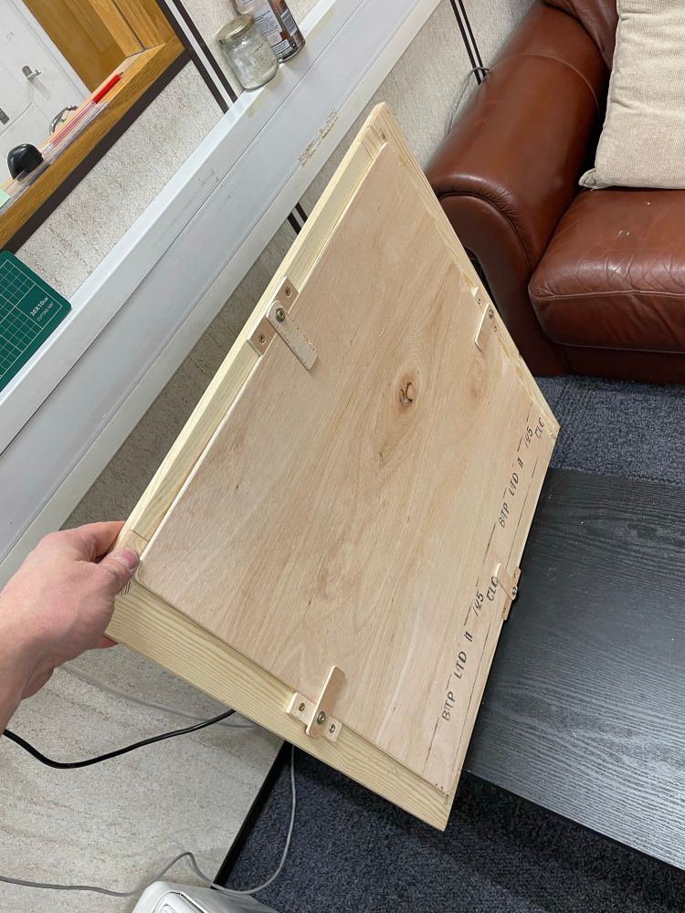 A square-ish picture frame with pinned bridle
Joints and routed edges made
From plain deal 3/1.

View from the back, showing four very rough back play catches made from 5mm ply