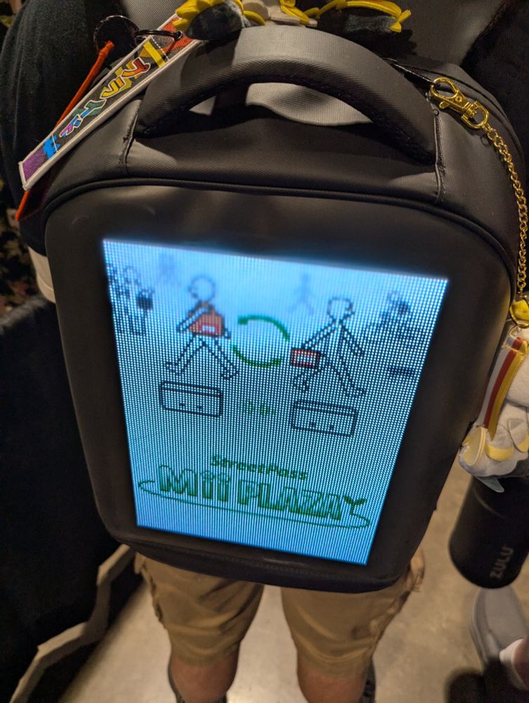LED backpack with a sign showing how StreetPass works