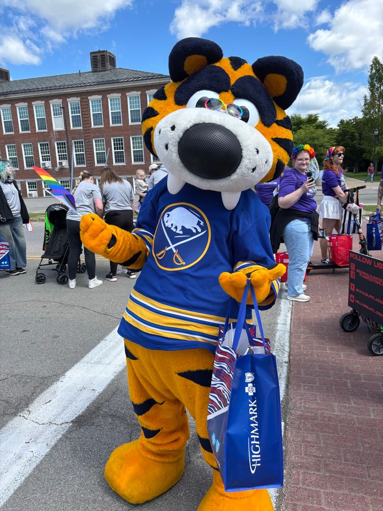 Sabretooth waving a Pride flag and wearing Pride sunglasses 