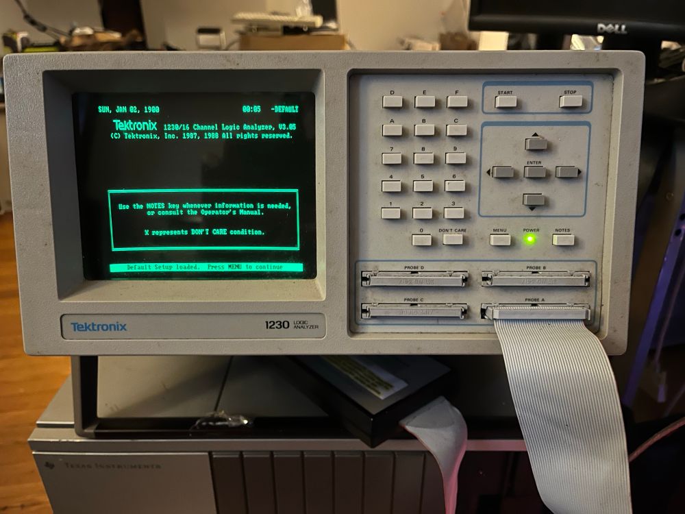 A Tektronix 1230 logic analyzer from 1989 with one probe connected via ribbon cable