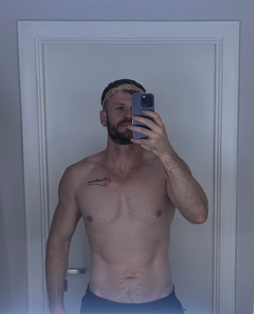 Topless selfie wearing wreath crown 