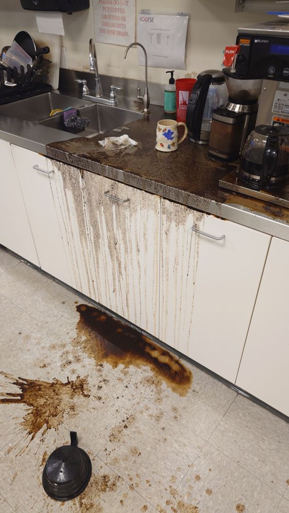 Spilled coffee brewer making a mess in a workplace kitchen