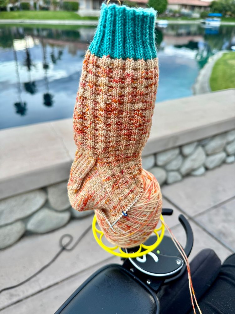 Handknit textured sock work in progress. Teal cuff and orange sock body. 