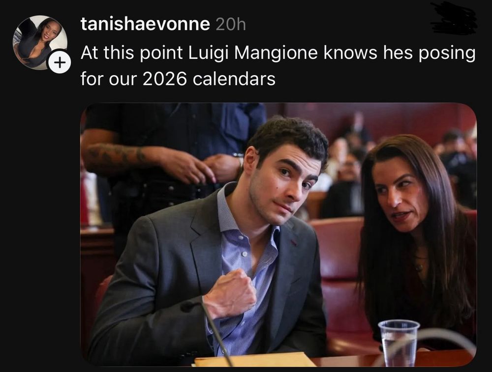 Picture of an attractive man posing from his legal defense table. The caption above from TanishaEvonne reads “At this point, Luigi Mangione knows hes posting for our 2026 calendars”