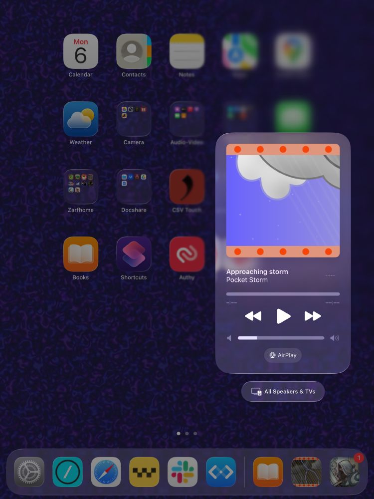 Screenshot of an iPad running Pocket Storm, with the Now Playing media widget showing. The widget shows the Pocket Storm weather phase, stylized clouds and a bit of rain, labelled “Approaching storm”.
