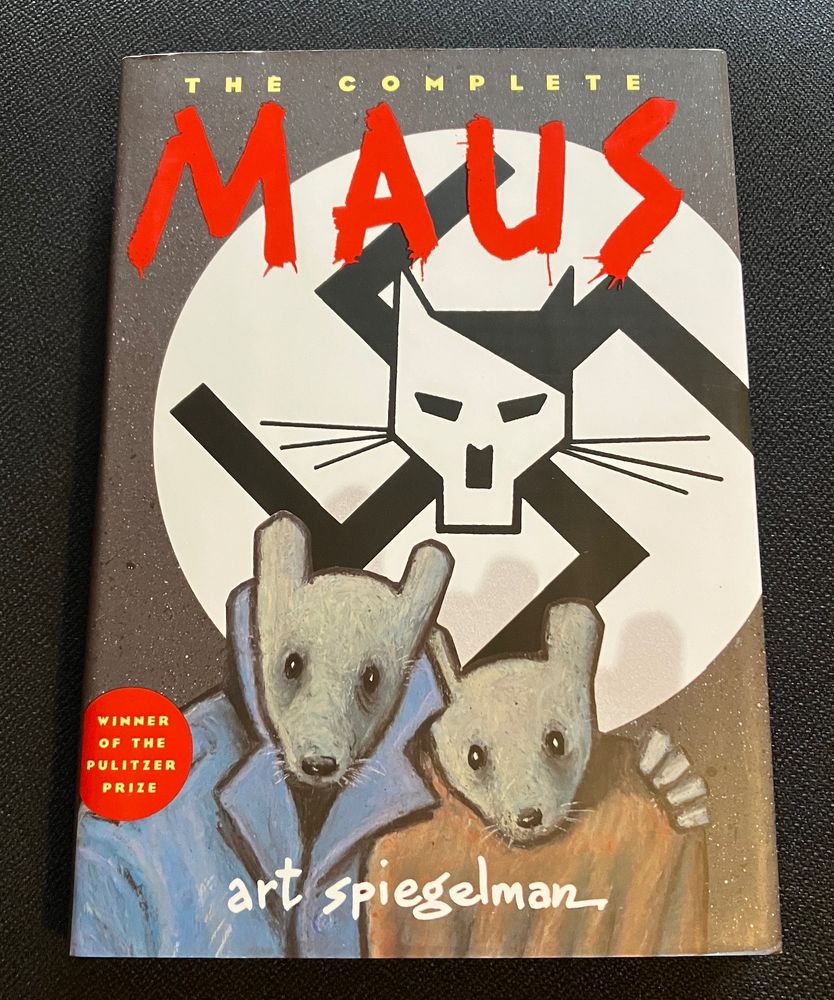 The cover of "Maus" by Art Spiegelman. Two anthropomorphic cartoon mice huddling under a banner with a swastika and stylized cat.