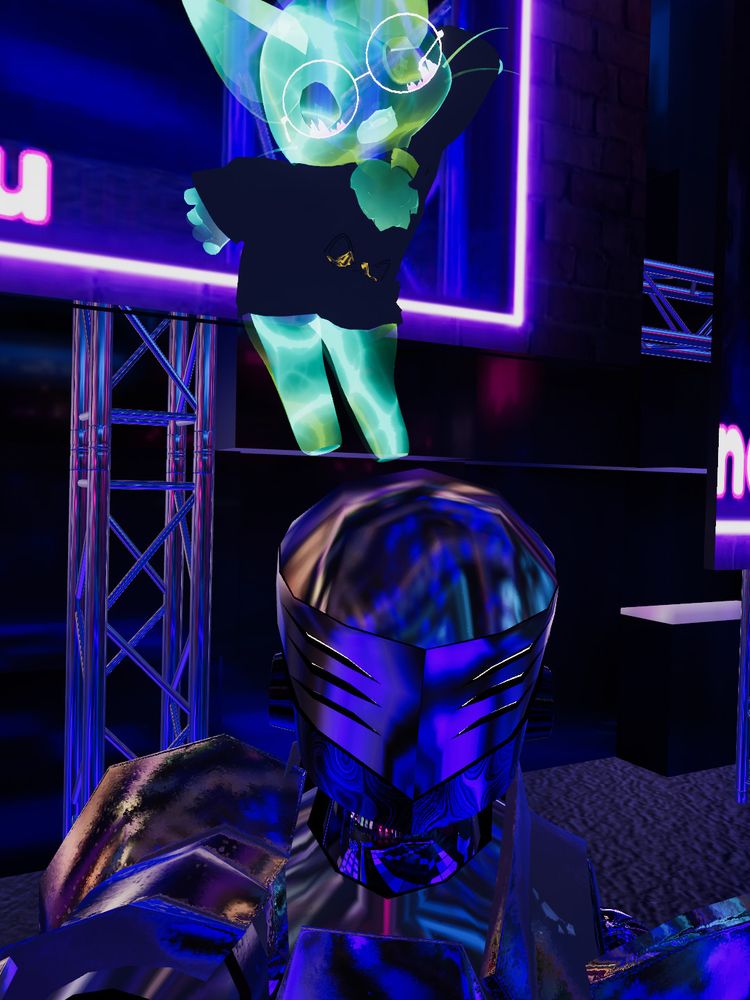 The same gold robot now with a bright green cat dancing on his head.