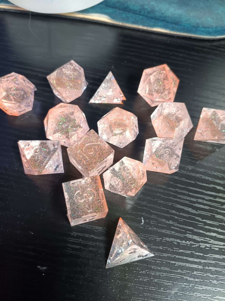 clear dice with orange glitter inside
