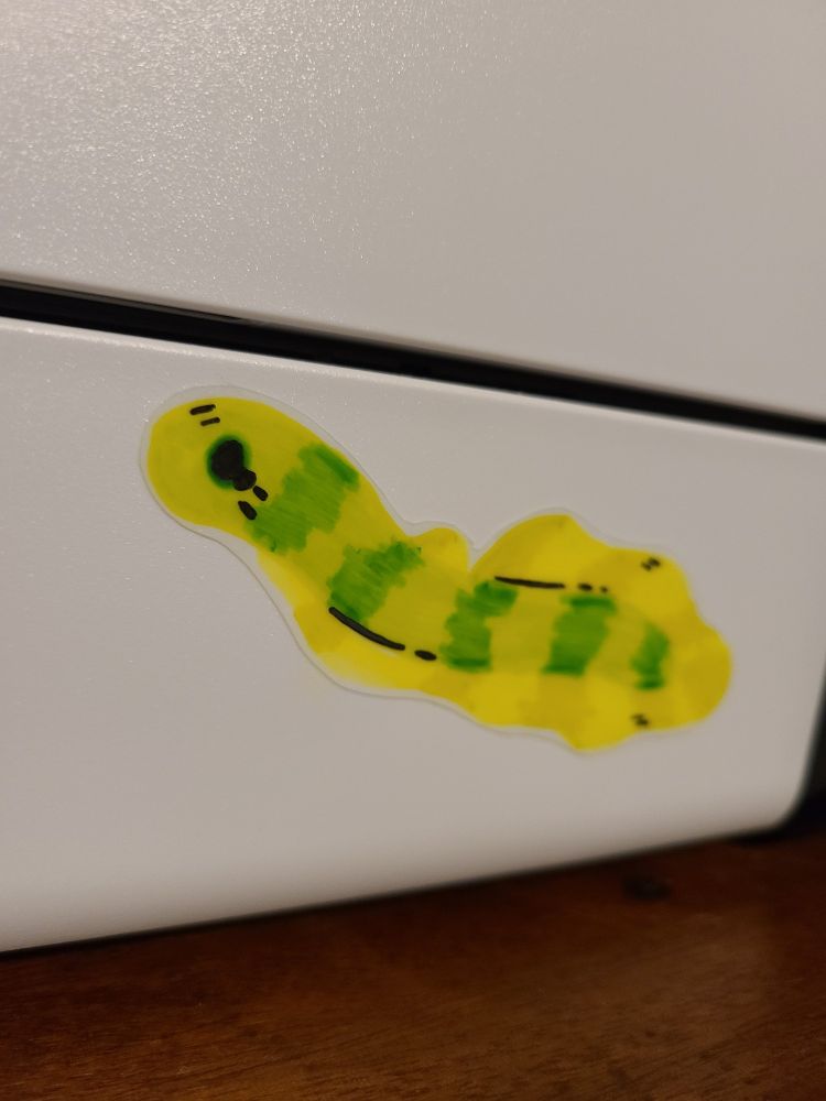 Yellow and green eel sticker on a printer