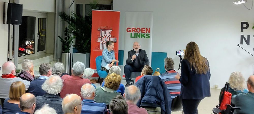 A packed local hall, with Frans Timmermans holding court in the middle of it all