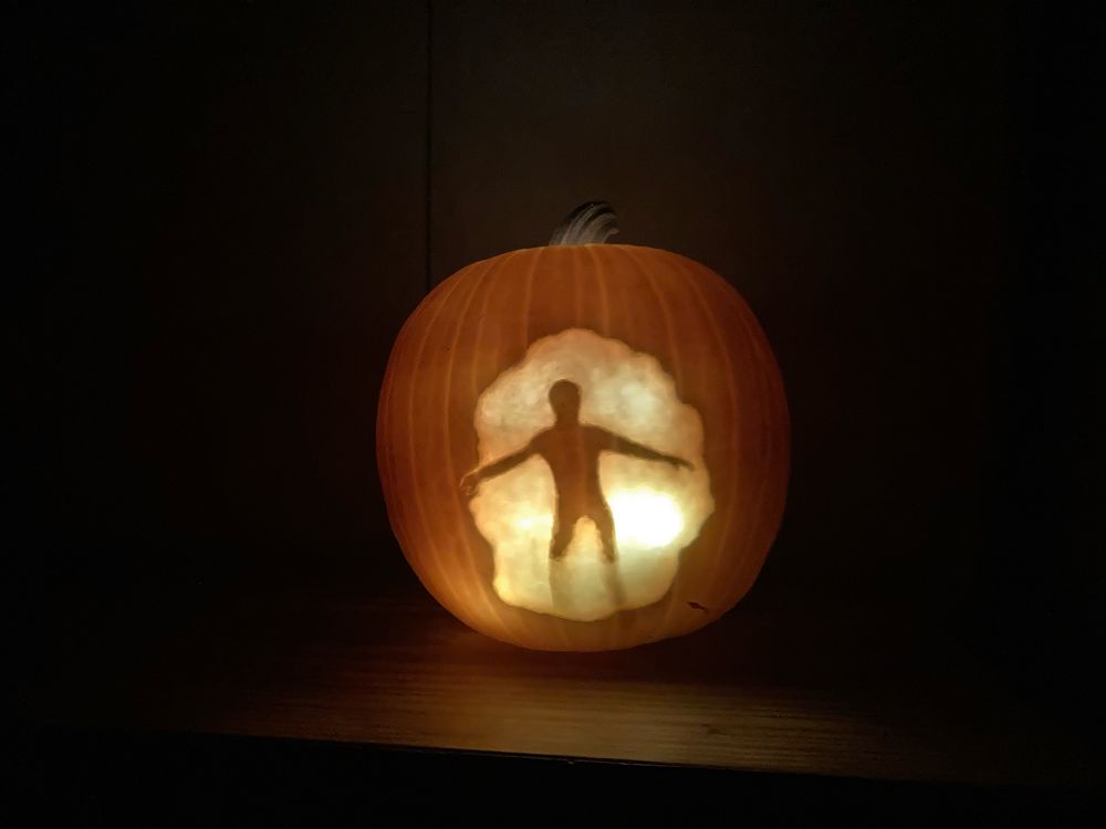 a pumpkin carved to look like sam from quantum leap when he steps into the quantum leap accelerator. his arms are spread out and hes backlit in a cloud of smoke, so i carved the pumpkin so his sillouette is dark, but the cloud is lit, although i didnt carve all the way through the pumpkin so it would look more like a cloud of smoke.