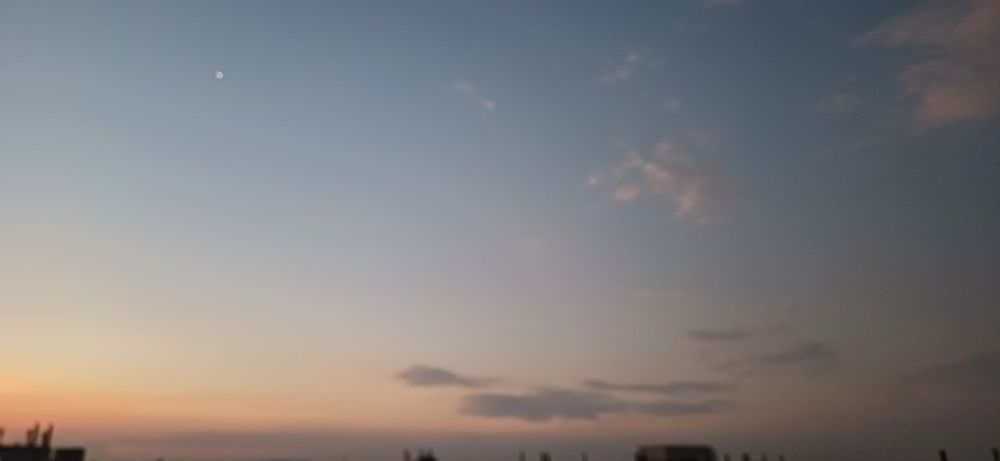 Evening star and some cloud looking west across some rooftops north of the ridge in Johannesburg.