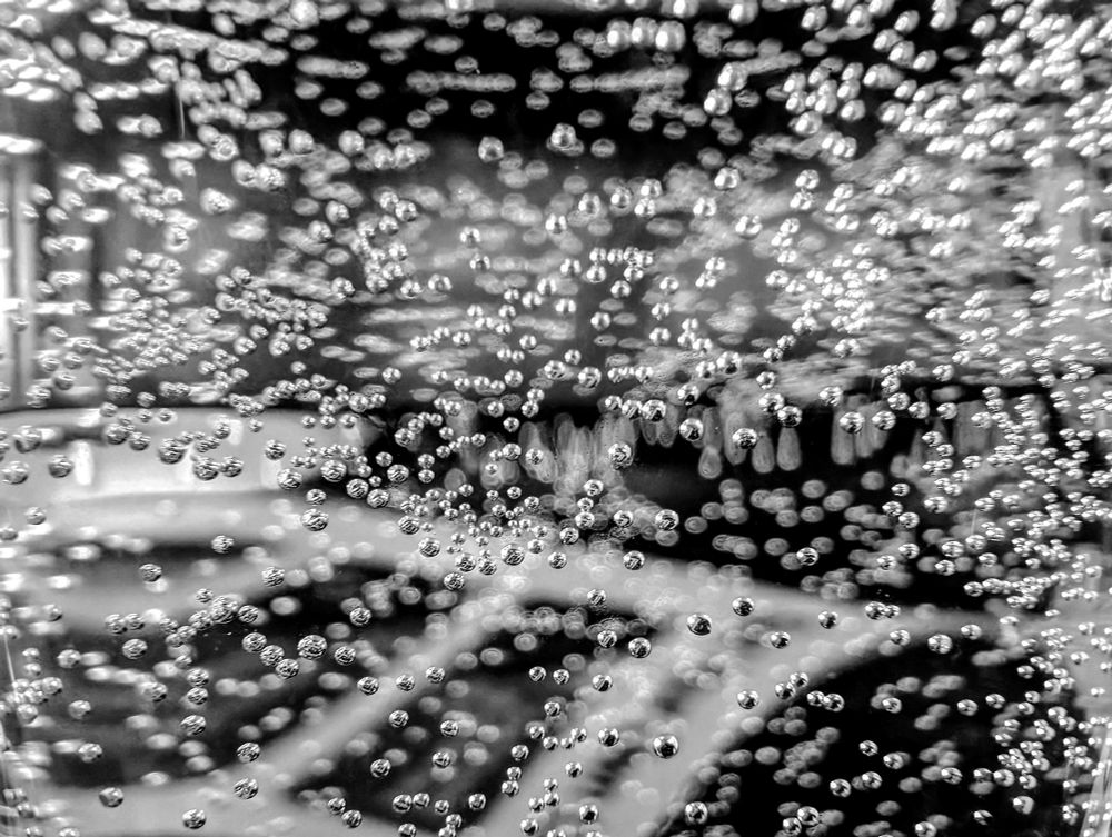 Close-up view of bubbles in a glass of sparkling water 