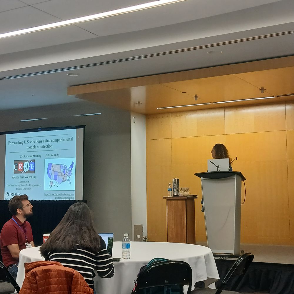 Photo of Alexandria Volkening giving a talk at the SMB meeting.