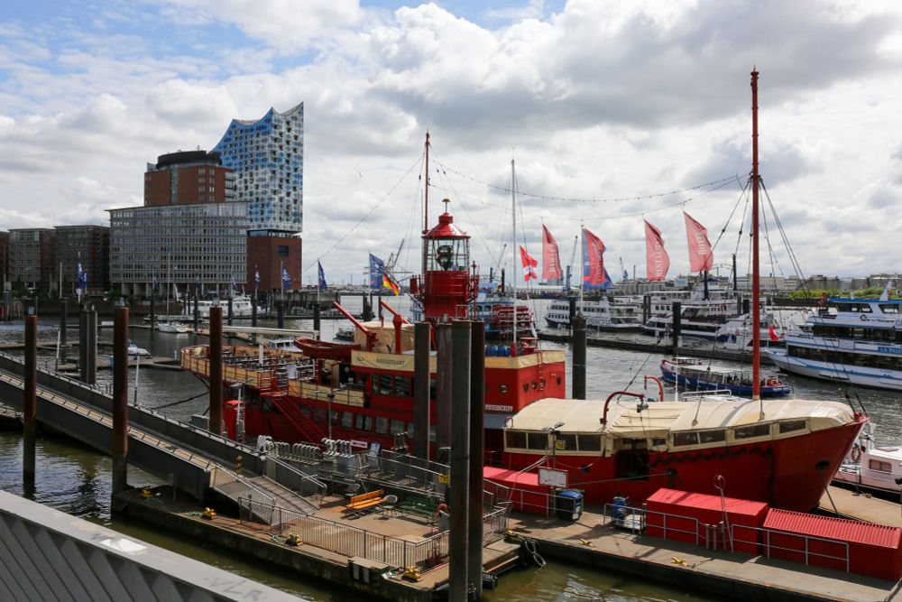 Hamburg harbour showing the 'Feuerschiff' restaurant with the Elbphilharmonie concert hall in the background. 