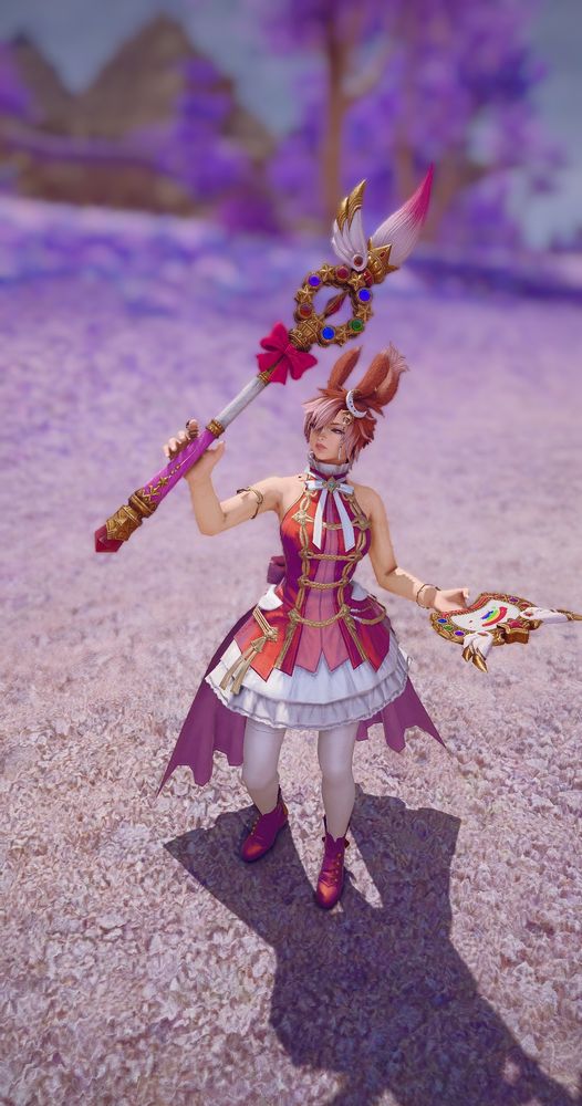 A bunny woman holding up a magical girl staff wearing a beautiful red dress. The background is a soft lavender treeline. 