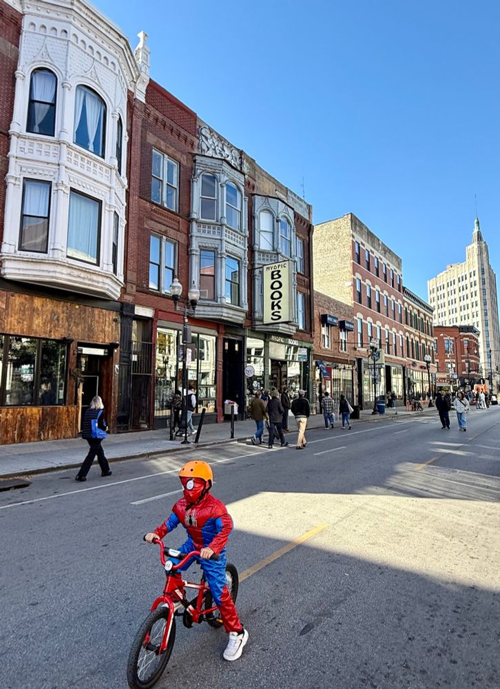 My photo of a pedestrianized Milwaukee Avenue in Chicago with a child on a bike in a Spider-Man costume.