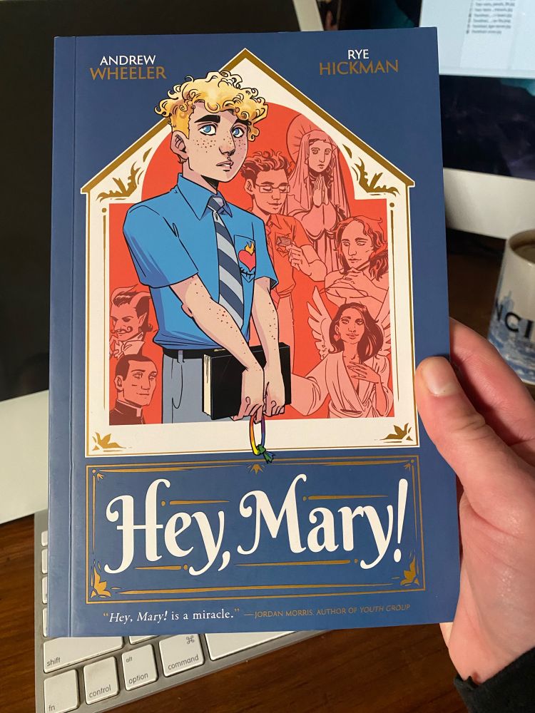 Rye holding a copy of Hey, Mary!