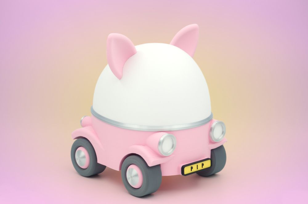 A playful little toy car with an egg shaped dome and little animal ears. The car is pink and is set against a glowing yeloow pink background.