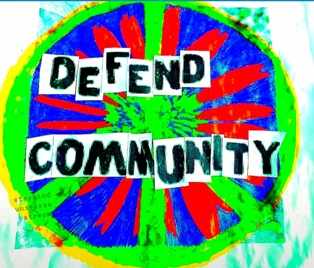 a peace sign saying defend community