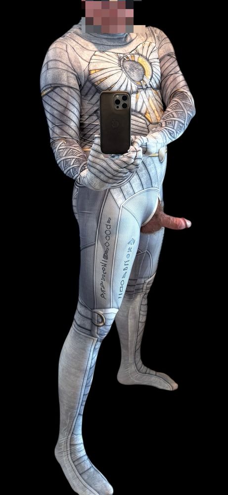 An aroused man in a tight spandex superhero suit