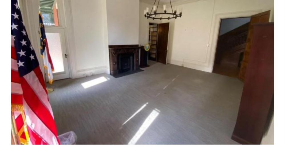 A room in the empty mansion. Even the drapes are missing.