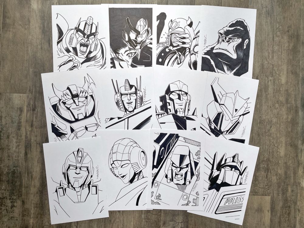 Photo of twelve black and white illustrated portraits of Transformers characters.

From left to right, top to bottom:
- Beast Wars Dinobot, Rattrap, Tarantulas and Optimus Primal in beast mode;
- EarthSpark Jawbreaker, Optimus Prime, Megatron and Soundwave
- G1 Hot Rod and Arcee, and G2 Megatron and Optimus Prime
