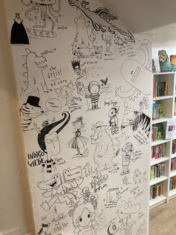 A wall with lots of illustrations from different children’s illustrations. 