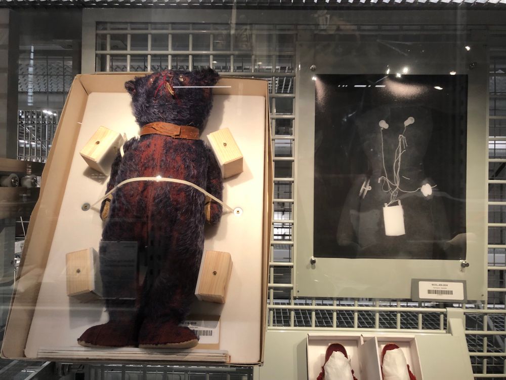 A teddy bear strapped in to the left, and an X-ray of same to the right 