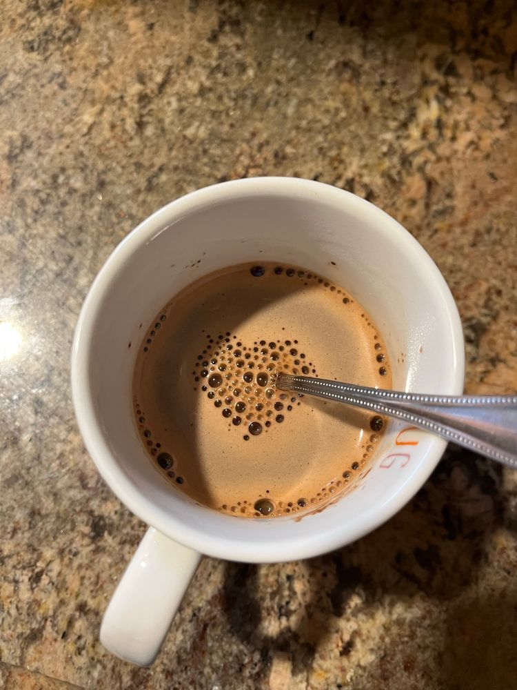 A pic of my hot chocolate. The little bubbles on the top have gathered around the spoon and look like a heart.