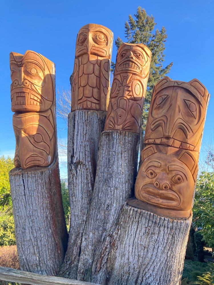 Totem pole carved from a set of stumps in someone’s front yard